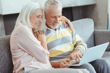 Loving aged couple sitting on the couch