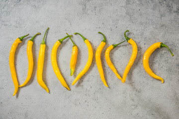 Yelow peppers on stone slate