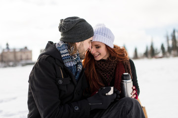 Couple in winter park touching foreheads