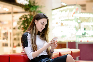 Beautiful girl picks up a message on the phone.
