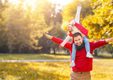 happy family father and  child   daughter playing and laughing in autumn park