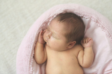 newborn baby sleeping on light background, toning