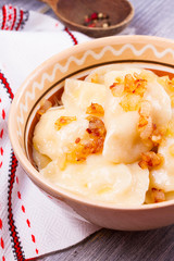 Dumplings, filled with potato and served with fried onion. Varenyky, vareniki, pierogi, pyrohy - popular dish in East Europe. Vertical