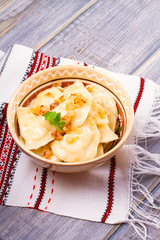 Dumplings, filled with potato and served with fried onion. Varenyky, vareniki, pierogi, pyrohy - popular dish in East Europe. Vertical