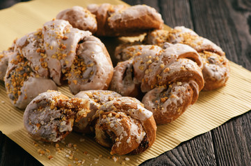 Croissant with almond filling on black wooden background.