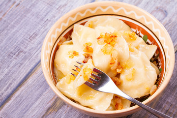 Dumplings, filled with potato and served with fried onion. Varenyky, vareniki, pierogi, pyrohy - popular dish in East Europe. Horizontal