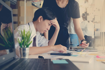  Shot of stressed asian business man in the office.