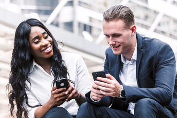 Two business people use technology together of smartphone