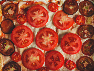 pizza (pie) with tomatoes on a dark background