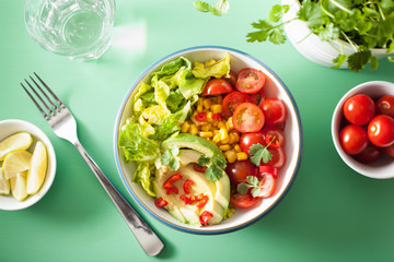 healthy vegan avocado salad with tomatoes and sweetcorn
