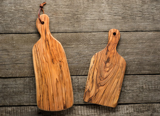 Olive wood Chopping Board on dark wooden background