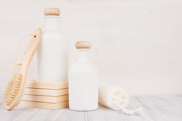 Bathroom interior. Blank white cosmetics bottles with shower puff, comb on white wood board, mock up. Soft elegant home decor for advertising, designers, branding identity, cover..