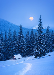 Christmas landscape with a house in the mountains