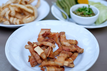Fried pork belly / fried streaky pork, snack made of deep fried pork meat with fatty skin. Famous food in Chiang Mai in Northern Thailand.