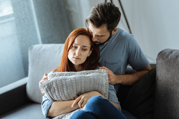 Handsome caring man hugging his girlfriend