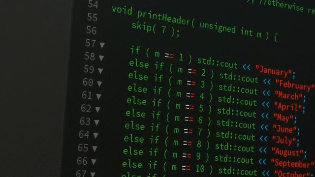 Programmer scrolling up and down and checking code for editing futuristic technology concept with grain and dark tone processed