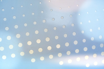 metal texture with circular holes of light blue Abstract background