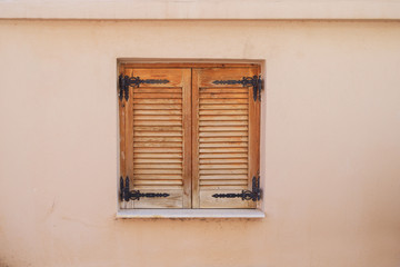 Wooden window with shutters in a Greek village