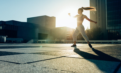 Female doing tricking practice outdoors in the city