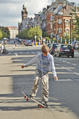 Young teenager boy practice skateboarding during the Car Free Streets day © pbombaert