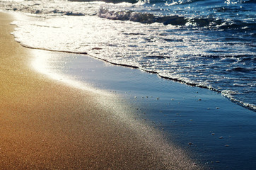 Serenity sand beach with waves. Sunny sea shore