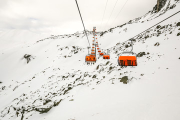 Winter mountain skiing resort panorama with ski lifts and ski slopes