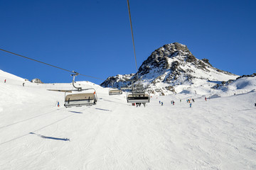 Fototapeta na wymiar Winter mountain skiing resort panorama with ski lifts and ski slopes