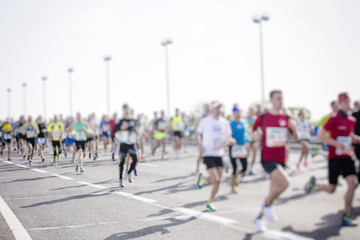 marathon runners ,motion blur running people in the city