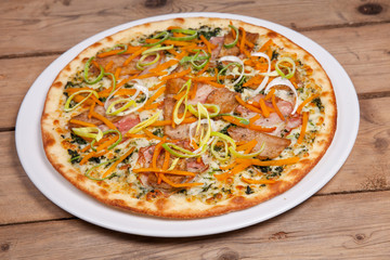 seasonal autumn pizza with onion vegetables carrot pumpkin and bacon