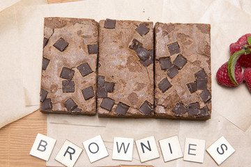 Chocolate brownie slices with raspberries and the word brownie 