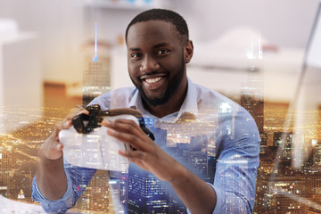 Optimistic man holding virtual glasses in hands