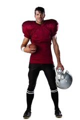 Portrait of smiling American football player holding ball and © WavebreakMediaMicro