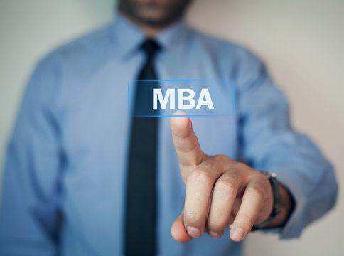 Businessman hand touching MBA text.
