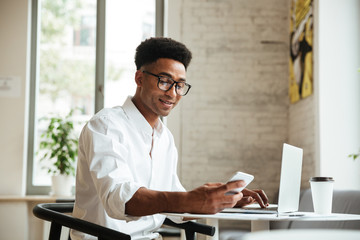 Handsome young african man sitting coworking