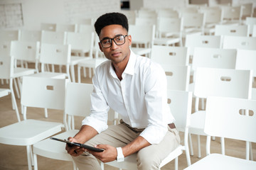 Fototapeta premium Young thinking african man sitting coworking
