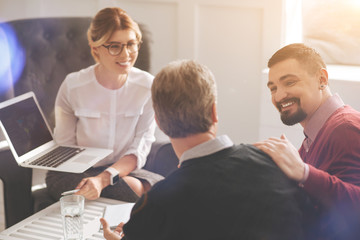 Obraz premium Delighted positive colleagues working in team