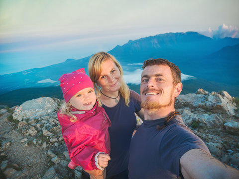 Family hikers making selfie on a top of mountain