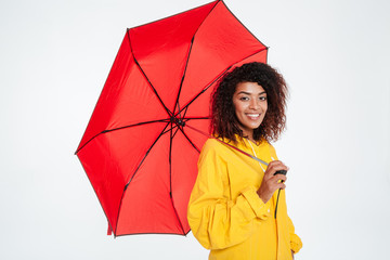 Side view of Smiling african woman in raincoat posing