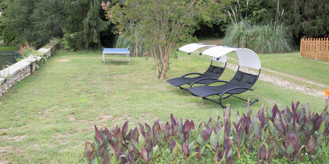 Two empty chairs on the grass Backyard garden idyll
