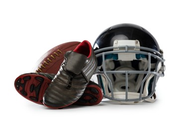 Close up of sports shoes with helmet and American football