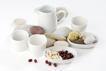 Diet pills with arrangement of coffee and tea cups