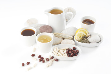 Diet pills with arrangement of coffee and tea cups