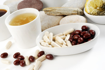 Diet pills with arrangement of coffee and tea cups