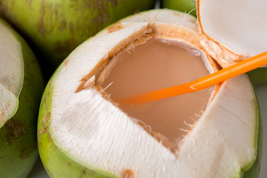 open fresh coconut with straw