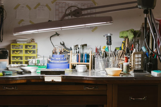 Illuminated jewellers workbench in jewellery workshop