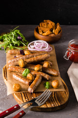 Grilled sausages with glass of beer on black table. Oktoberfest.
