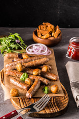 Grilled sausages with glass of beer on black table. Oktoberfest.