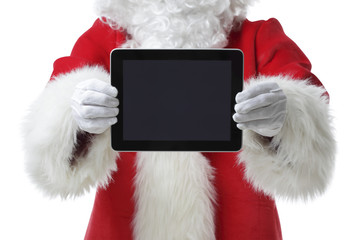 Christmas concept shot with Santa holding a digital tablet, showing it into the camera Isolated on white
