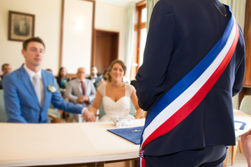 mayor man seen from behind at a wedding ceremony in france