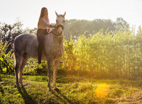 Woman riding a horse on farm at countryside